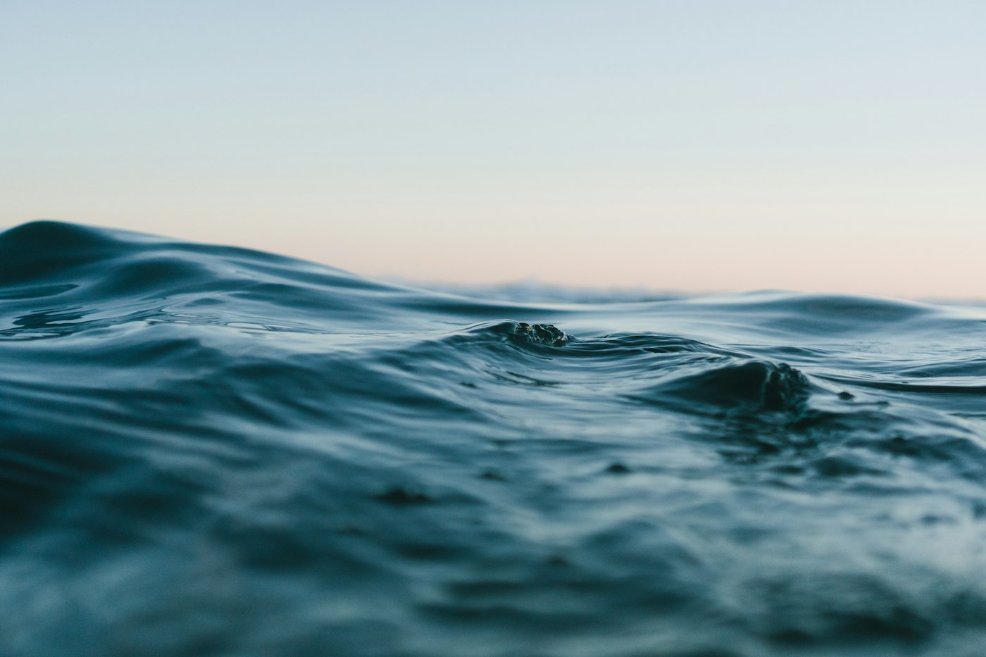 Gentle waves moving across a blue sea