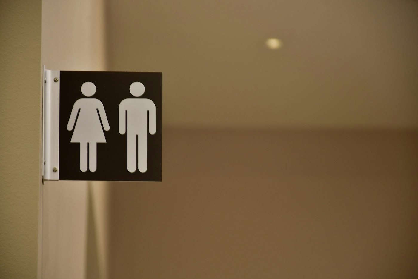 A clearly marked restroom sign on a wall