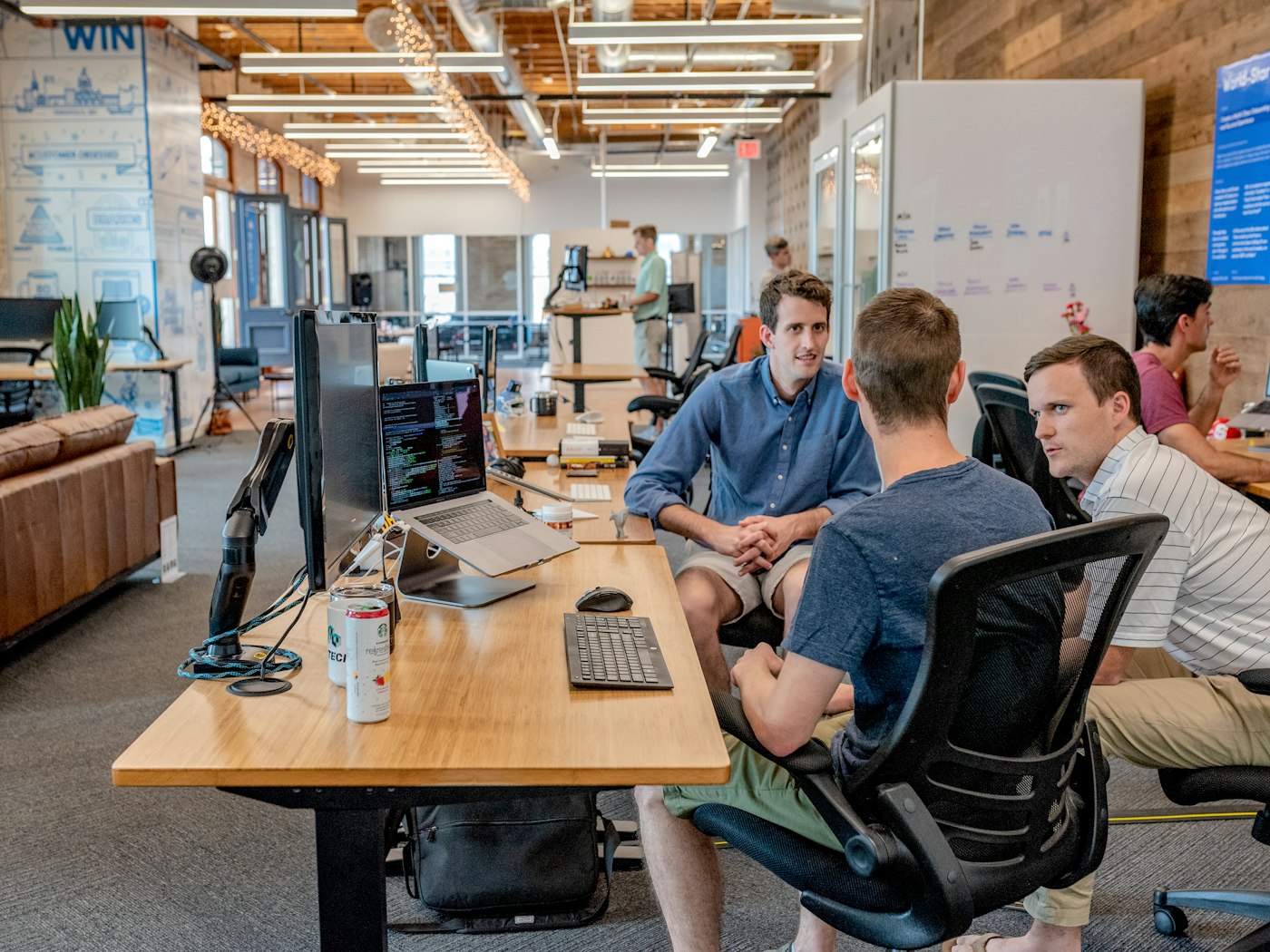 Colleagues discussing their work around a desk