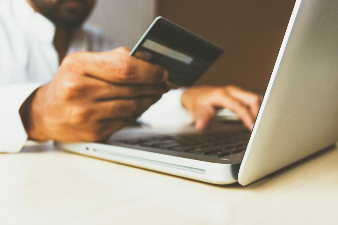 A person reviewing an online payment with a bank card