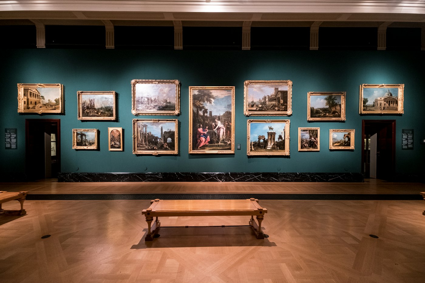 Framed paintings and benches in a quiet museum gallery