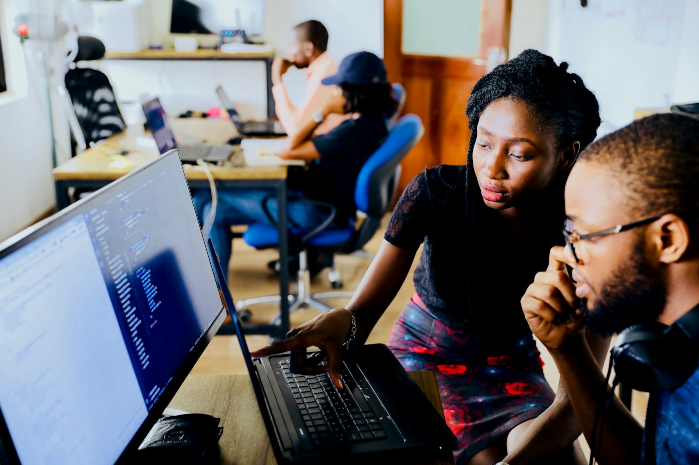 Two colleagues learning together at a computer