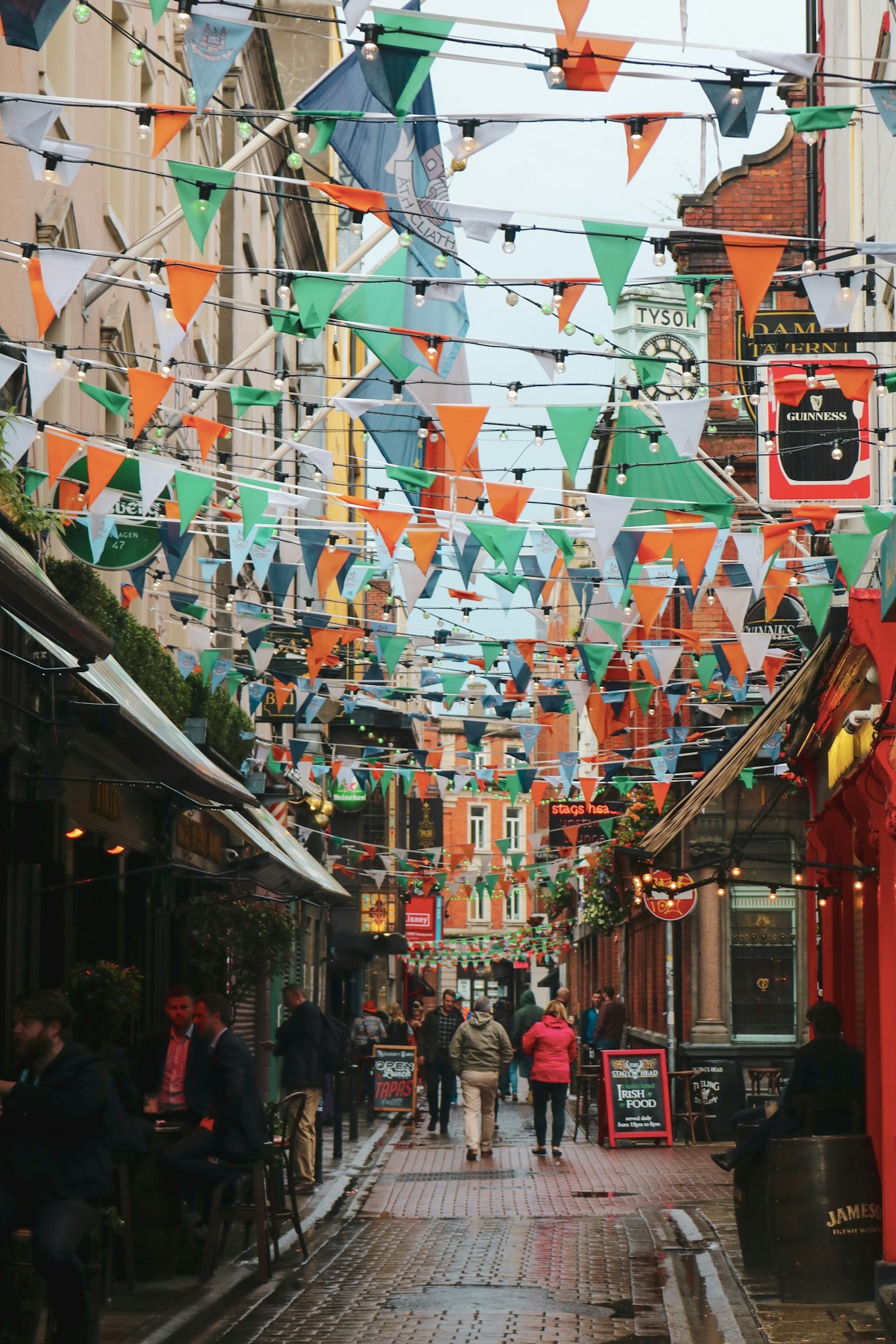 Colorful bunting and lights above a neighborhood street