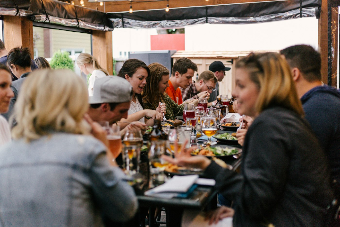 Friends sharing food around a long dining table