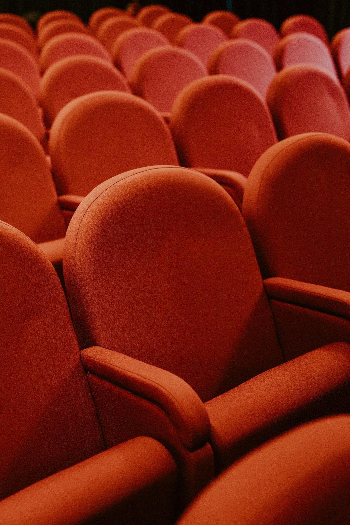 Rows of red seats in a cinema