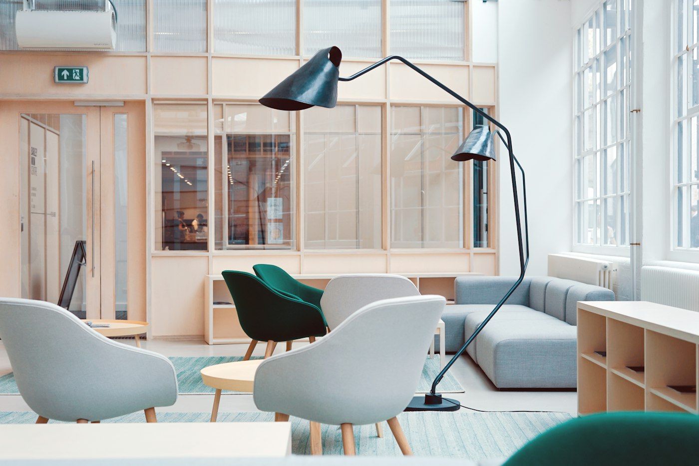 A shared office with seating and glass meeting rooms