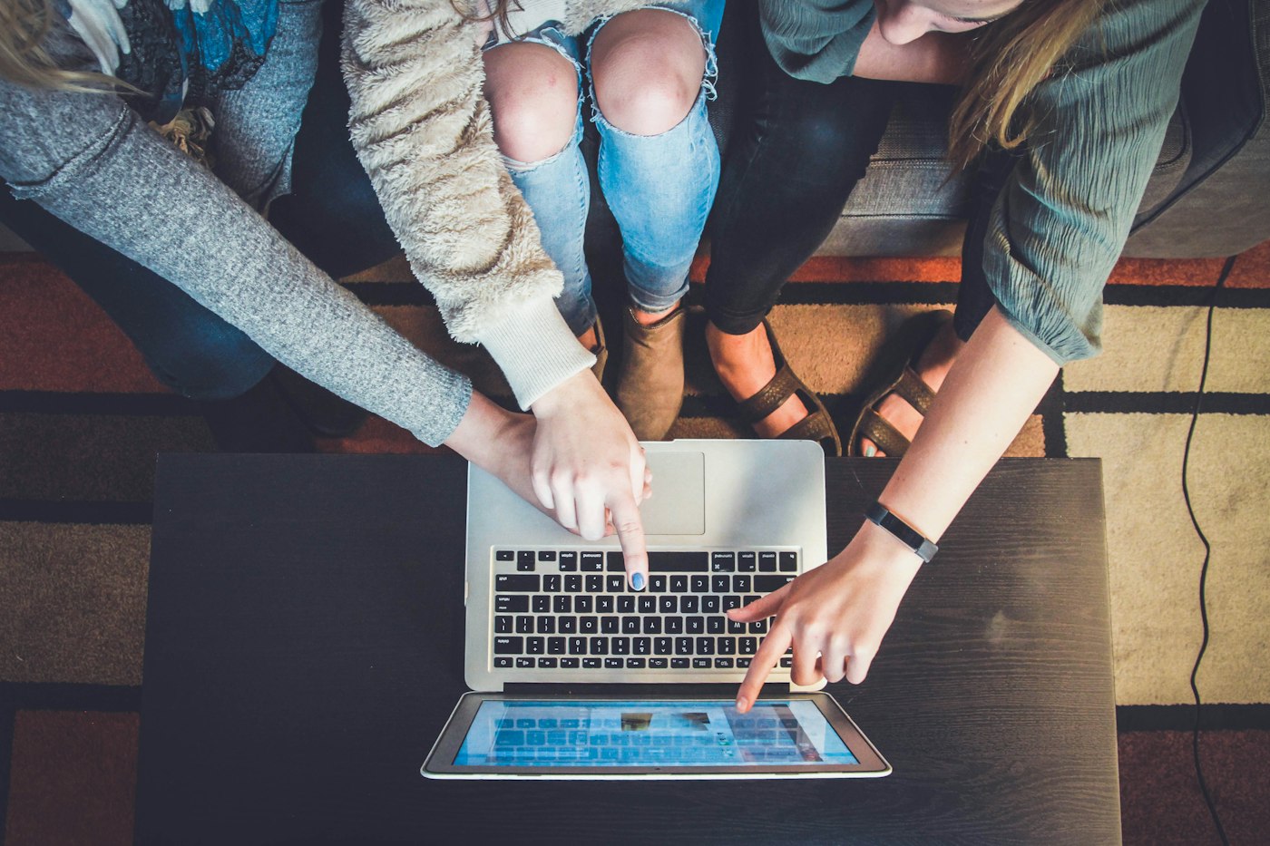 People working together on a laptop viewed from above