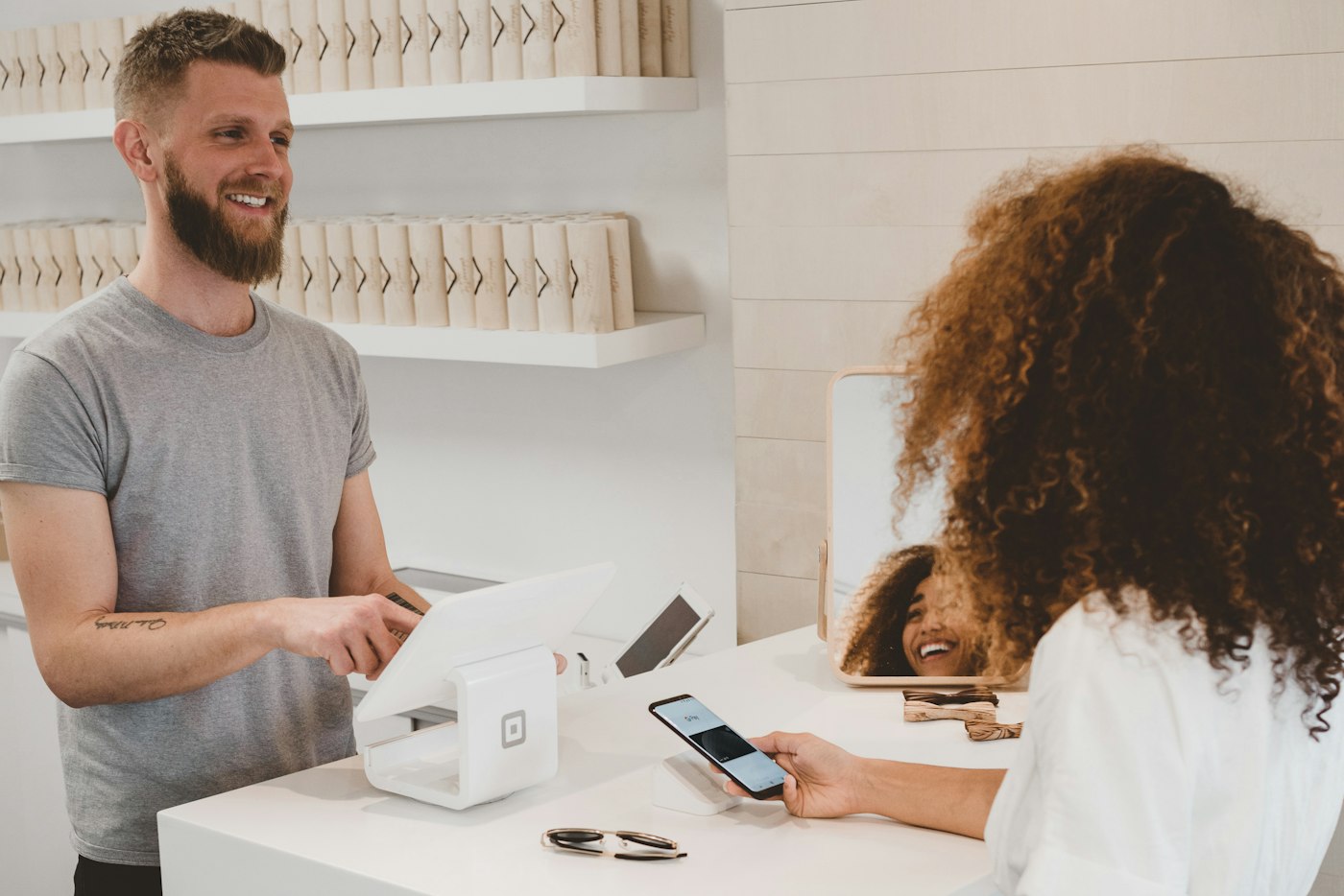 A customer and a shop assistant at a checkout counter