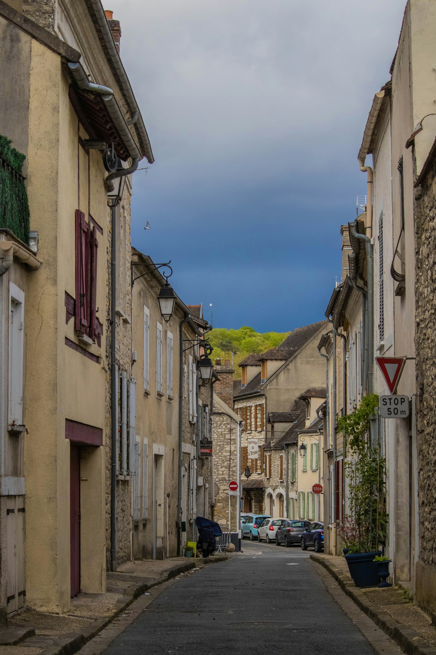 A winding village street between old stone buildings