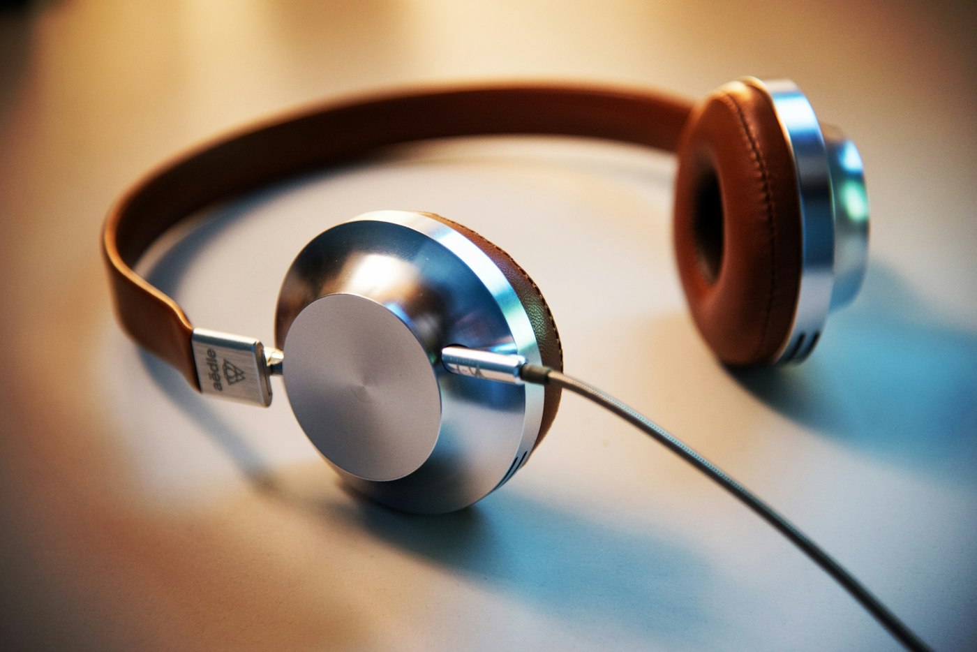 A pair of over-ear headphones on a wooden surface