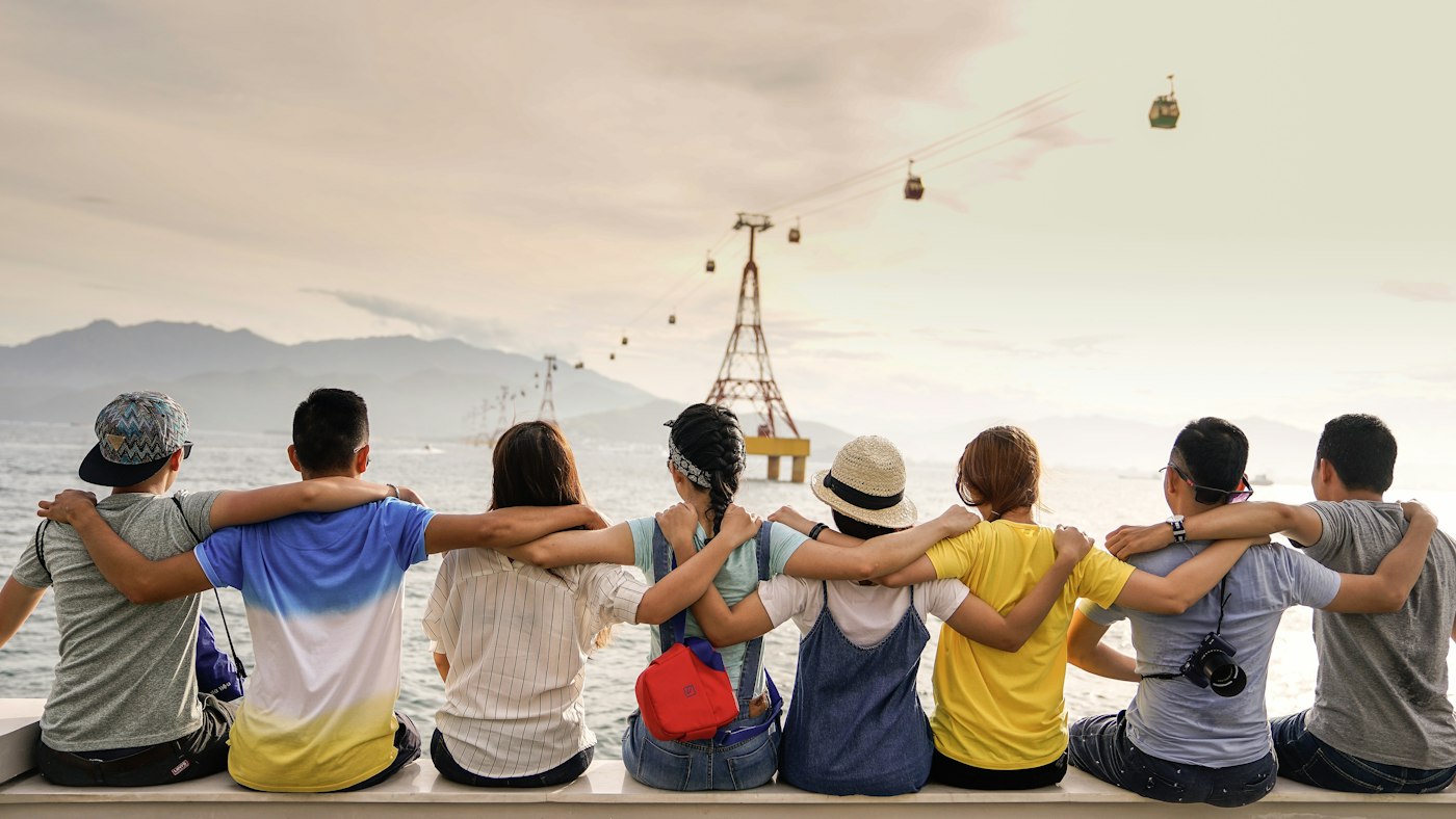 A group standing together with arms around one another