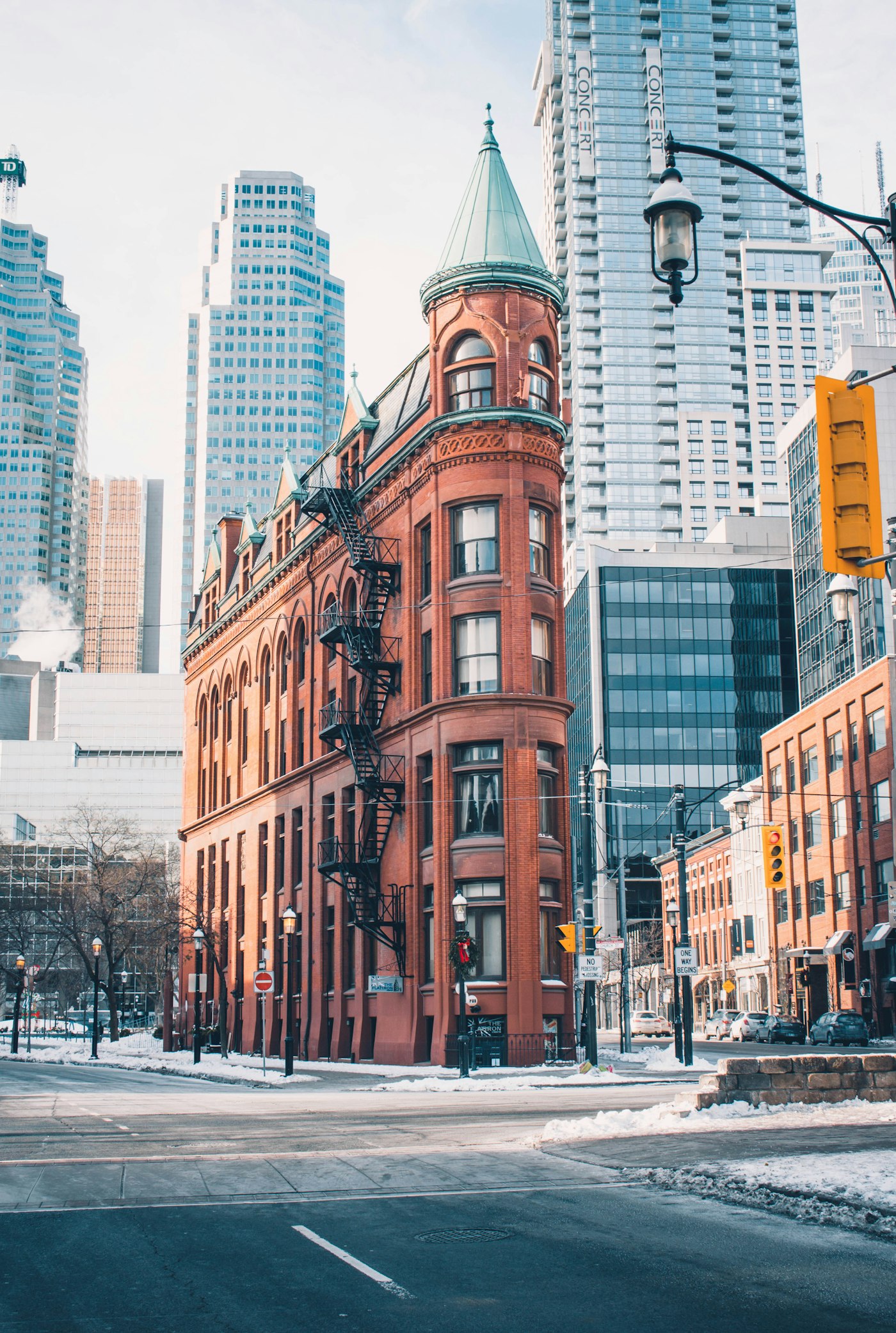 A historic corner building surrounded by a modern city