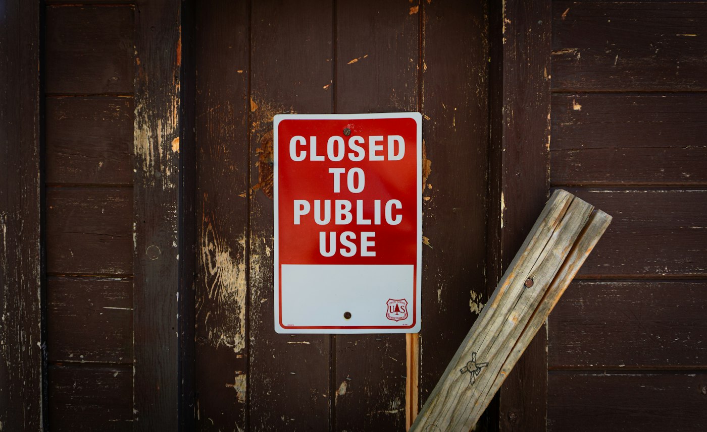 A public access notice attached to a wooden door
