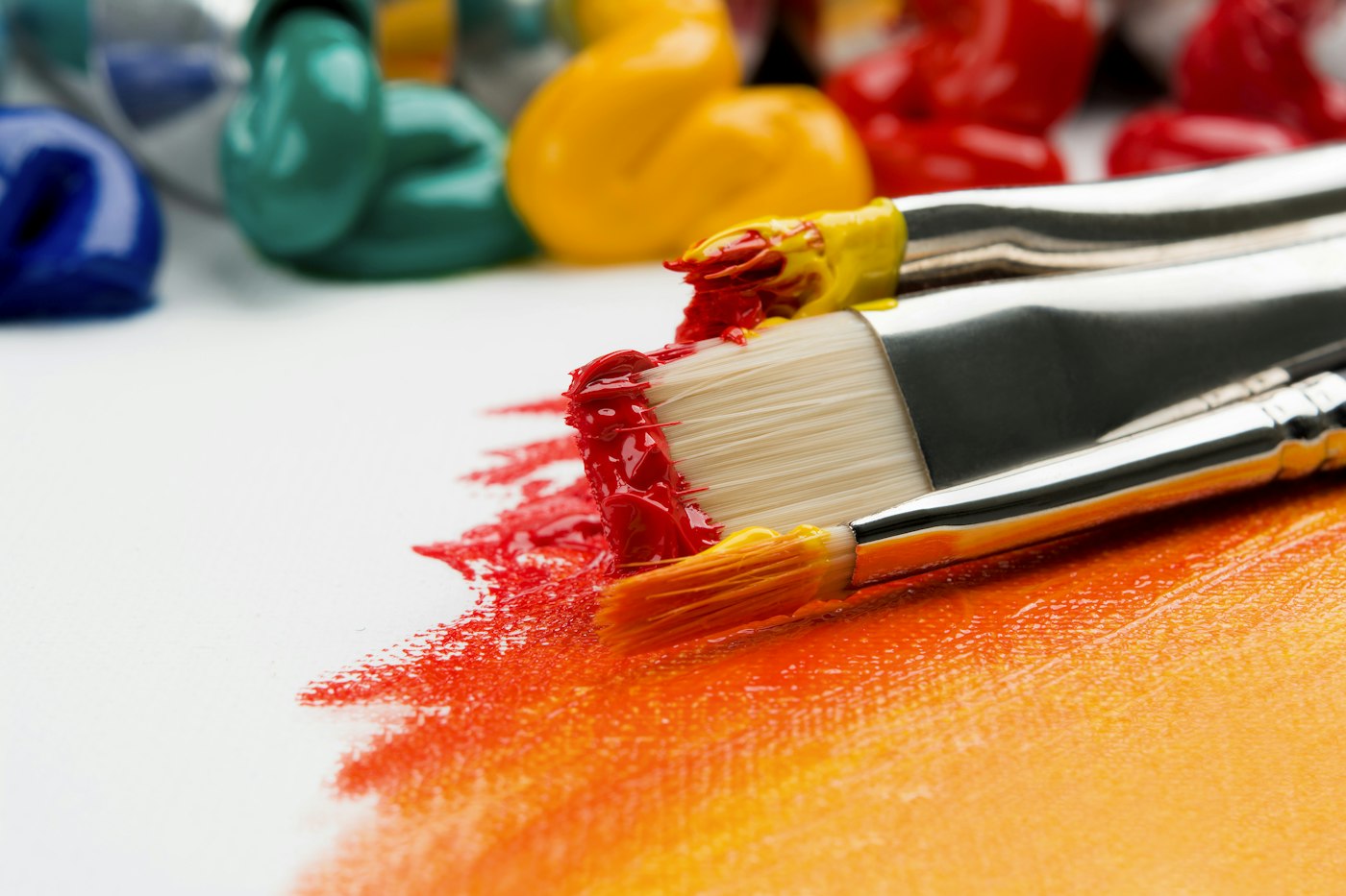 Paintbrushes and fresh colors laid out for creative work