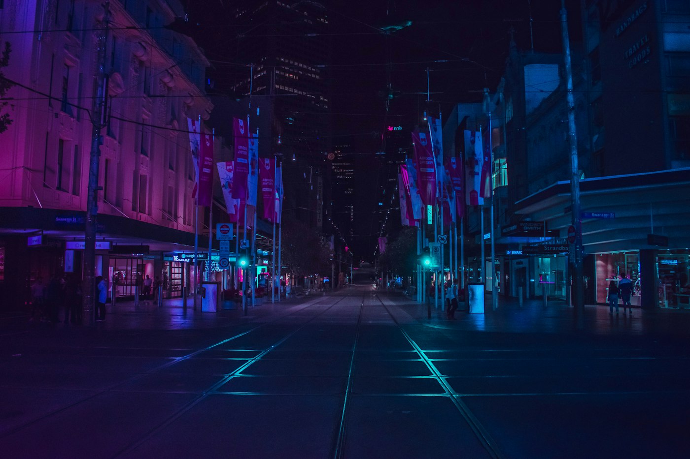 Street lights illuminating a quiet road after dark